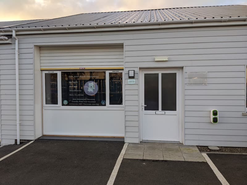 The Tidy Dog Grooming And Spa unit at Withybush Trading Estate at dusk, with parking directly outside